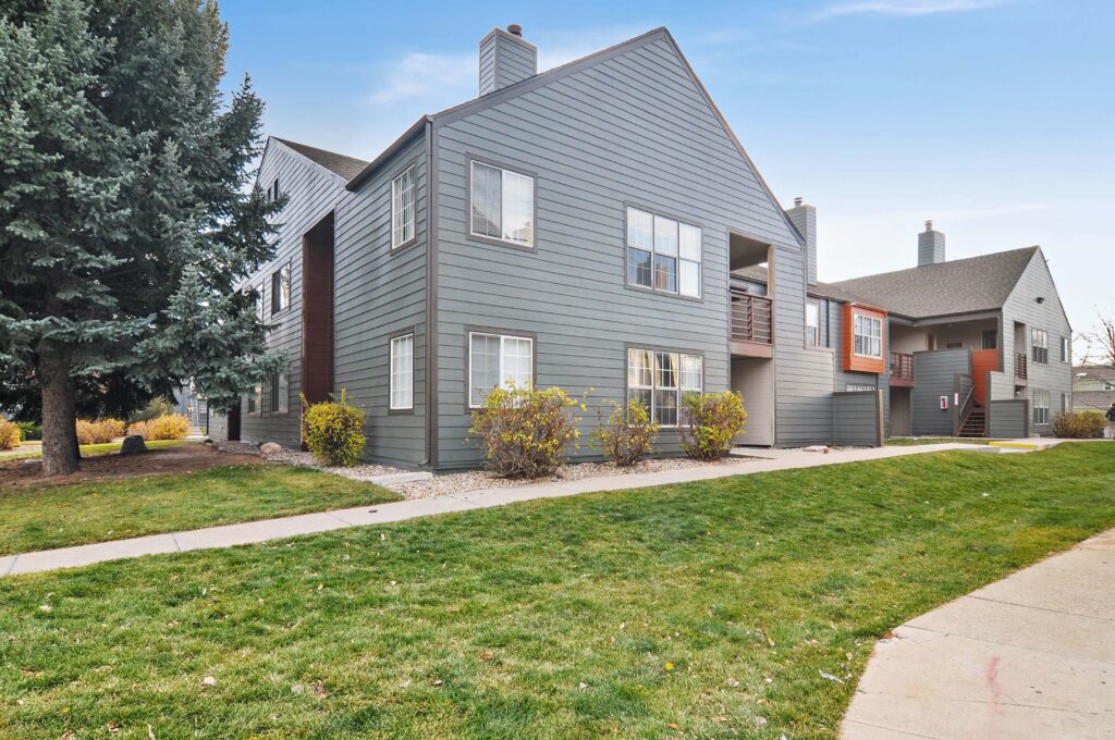 Building exterior with large trees and sidewalks