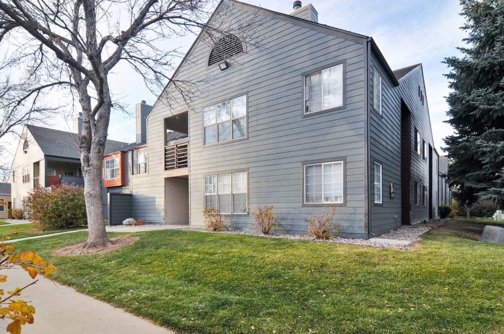 Building exterior with large trees and sidewalks