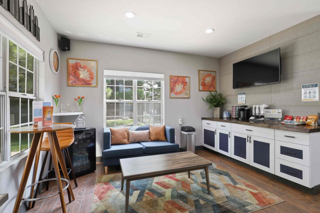 Leasing office lobby with sofas and TV