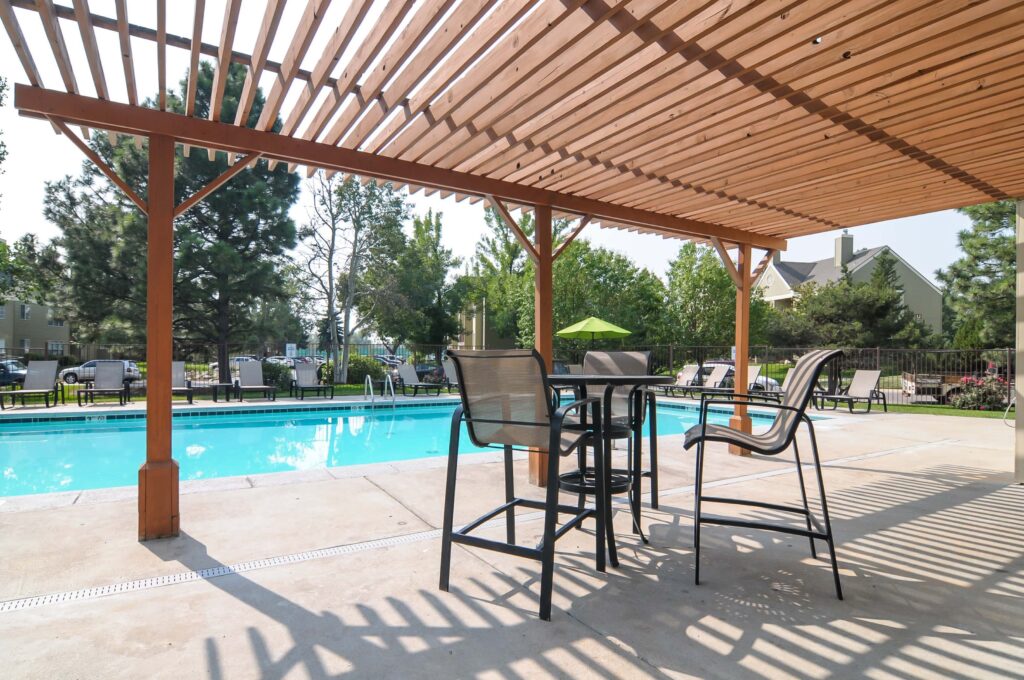 Pool view from shaded sitting area at Habitat at Fort Collins apartment complex