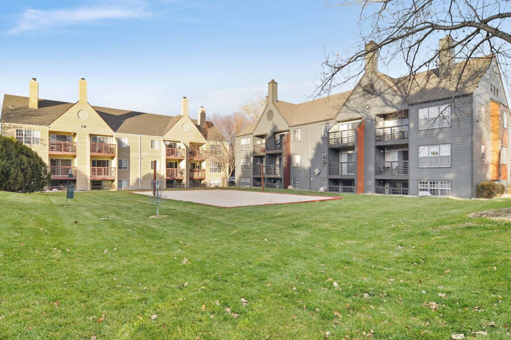 Exterior view of the buildings with sand volleyball court and disc golf