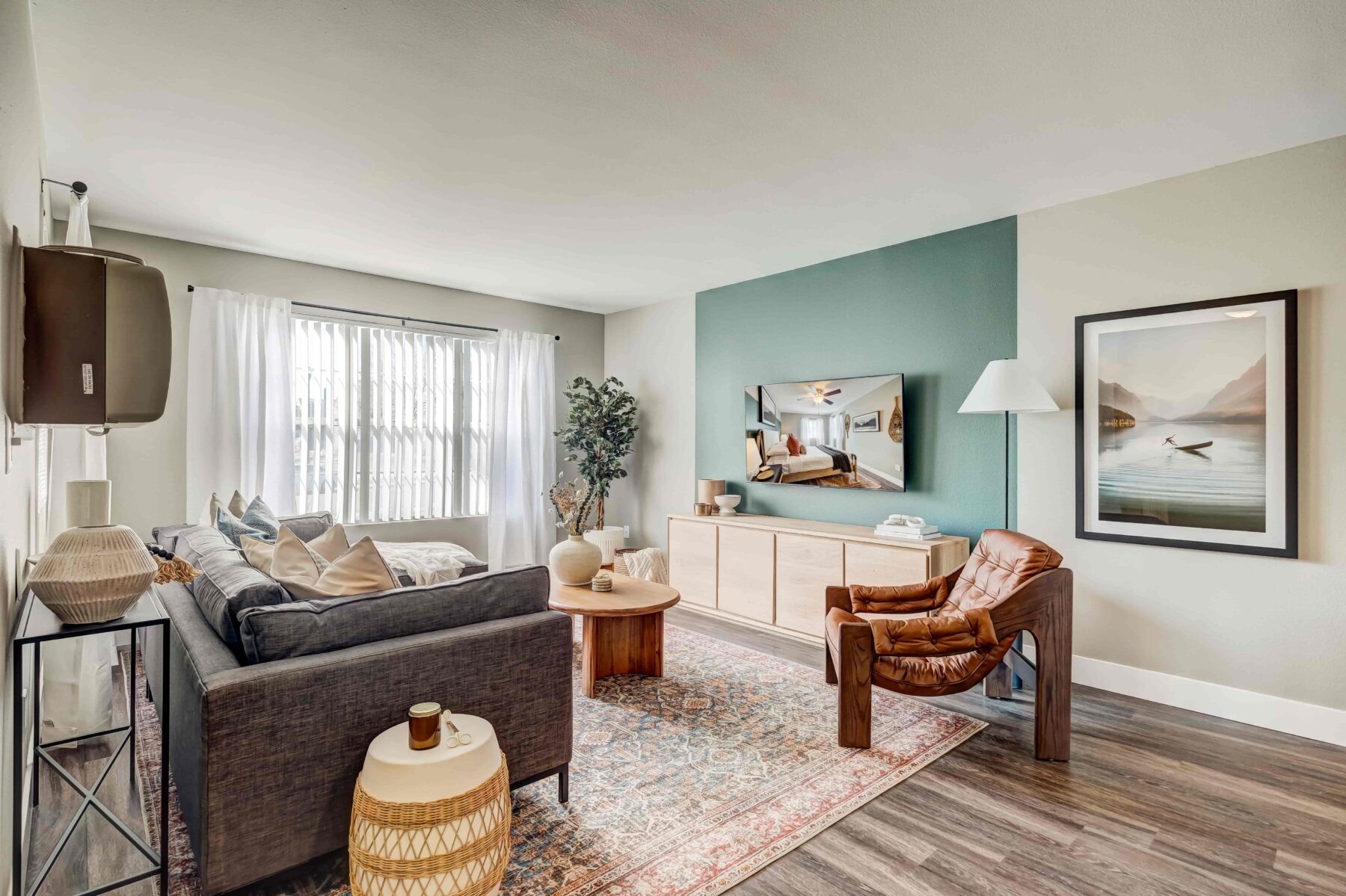 Living room with modern furniture, TV & a large wall art