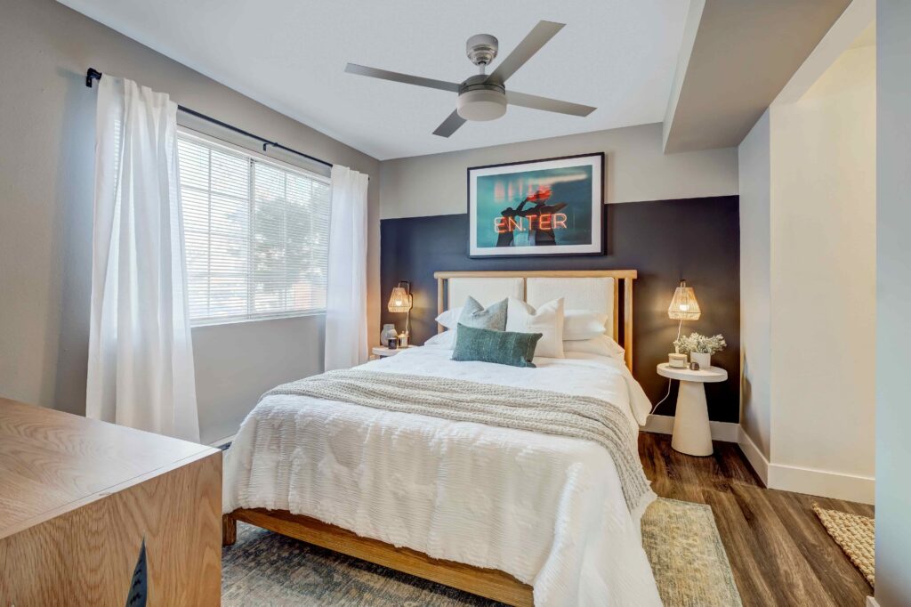 Bedroom with ceiling fan and large window