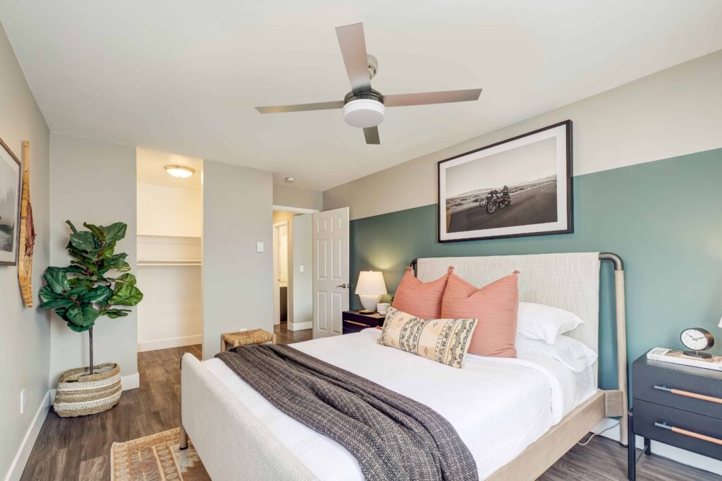 Bedroom with ceiling fan and walk in closet