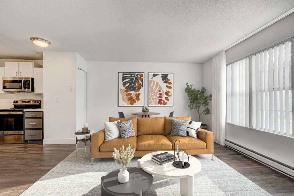 Living room with large windows adjacent to the kitchen